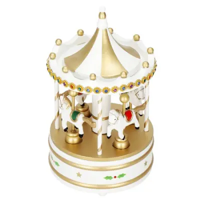 Karuzela z glasbo, bela in zlata božična dekoracija.